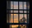 photo of blue framed glass window with curtain