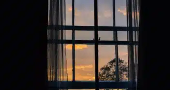 photo of blue framed glass window with curtain