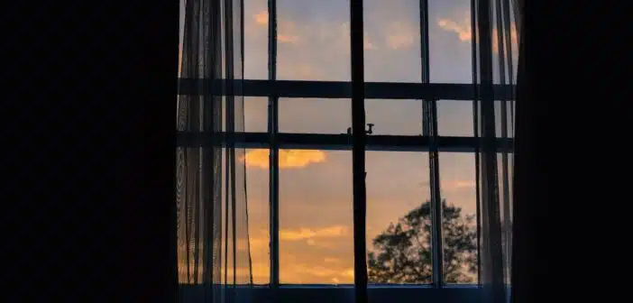 photo of blue framed glass window with curtain